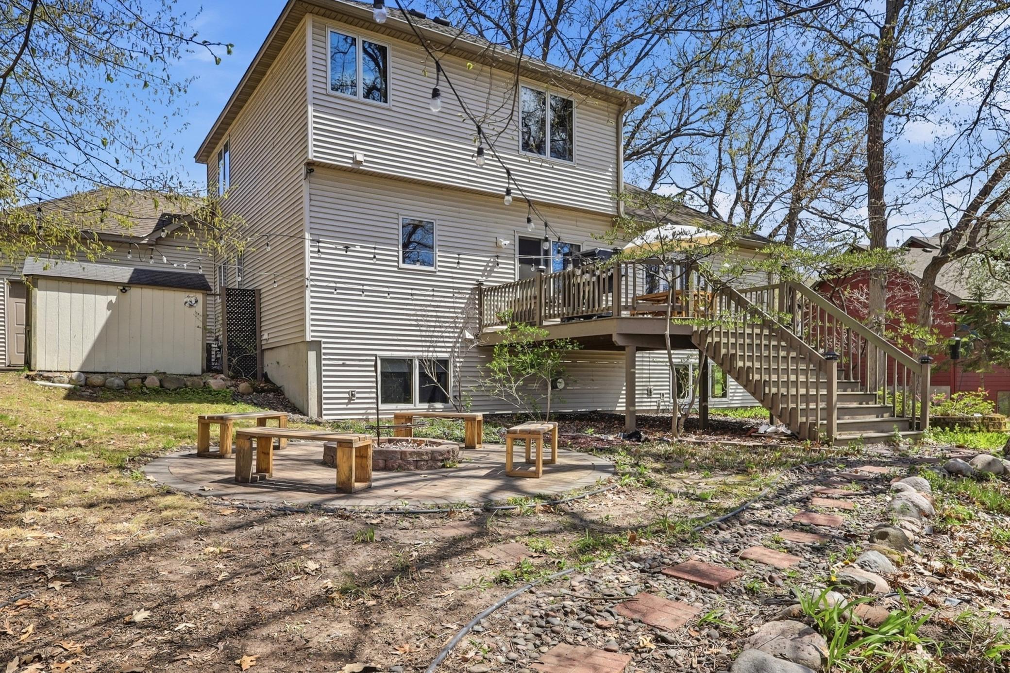 Private paver patio with a built in firepit, creating the perfect space to relax and enjoy the outdoors.