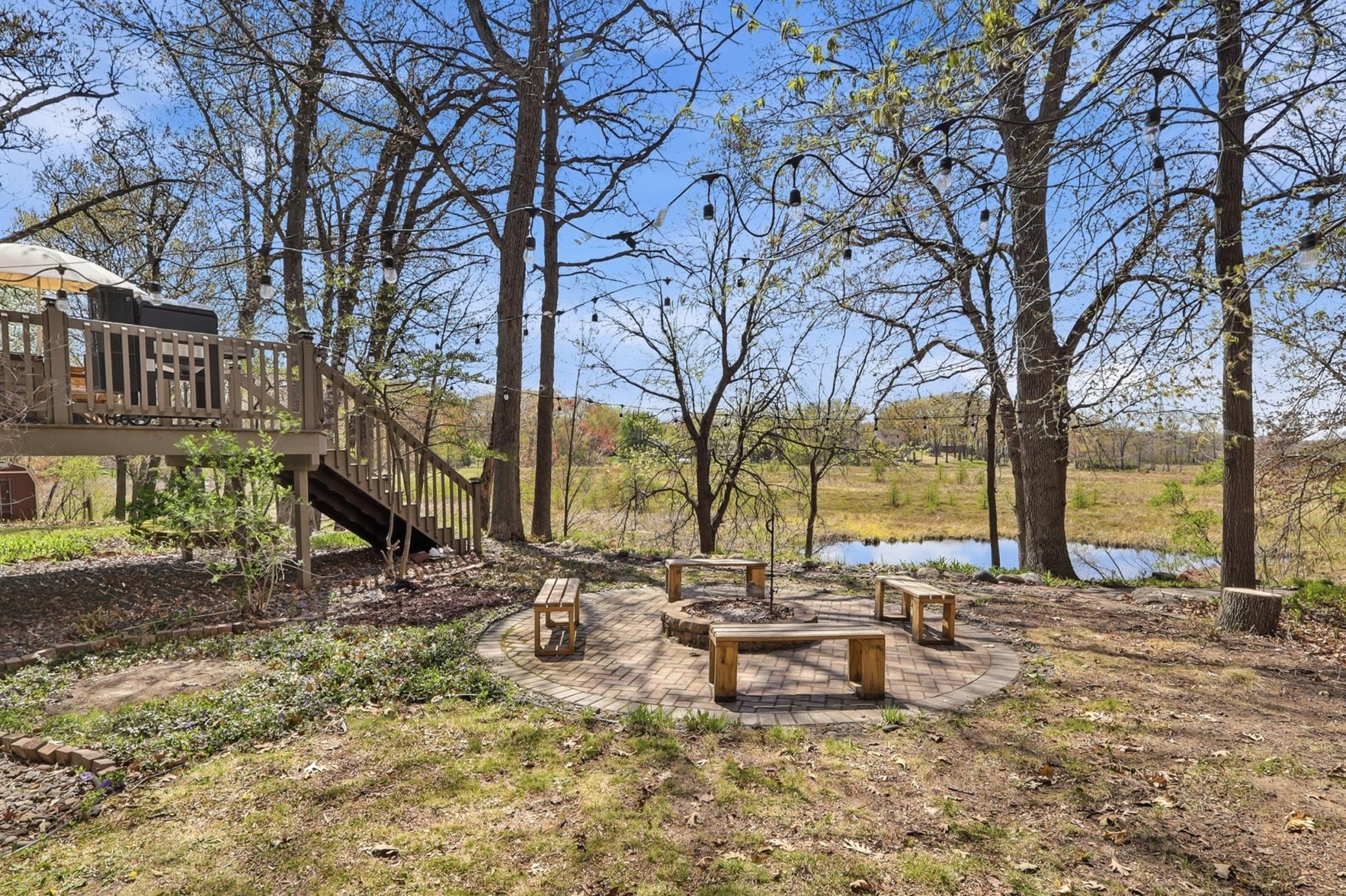 Private paver patio with a built in firepit, creating the perfect space to relax and enjoy the outdoors.