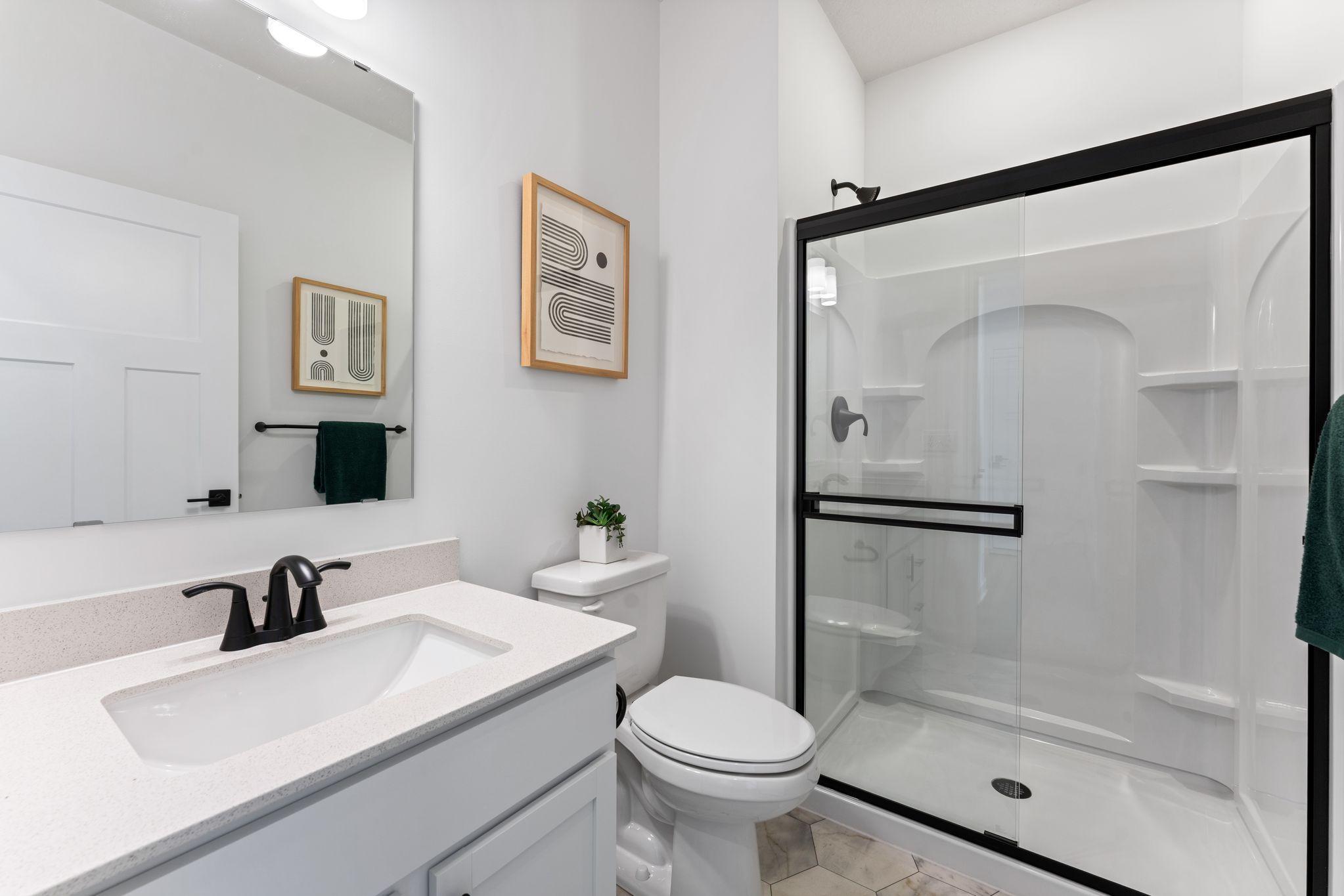 Conveniently placed near the main level bedroom, the main level bathroom is conveniently trucked away with privacy in mind.