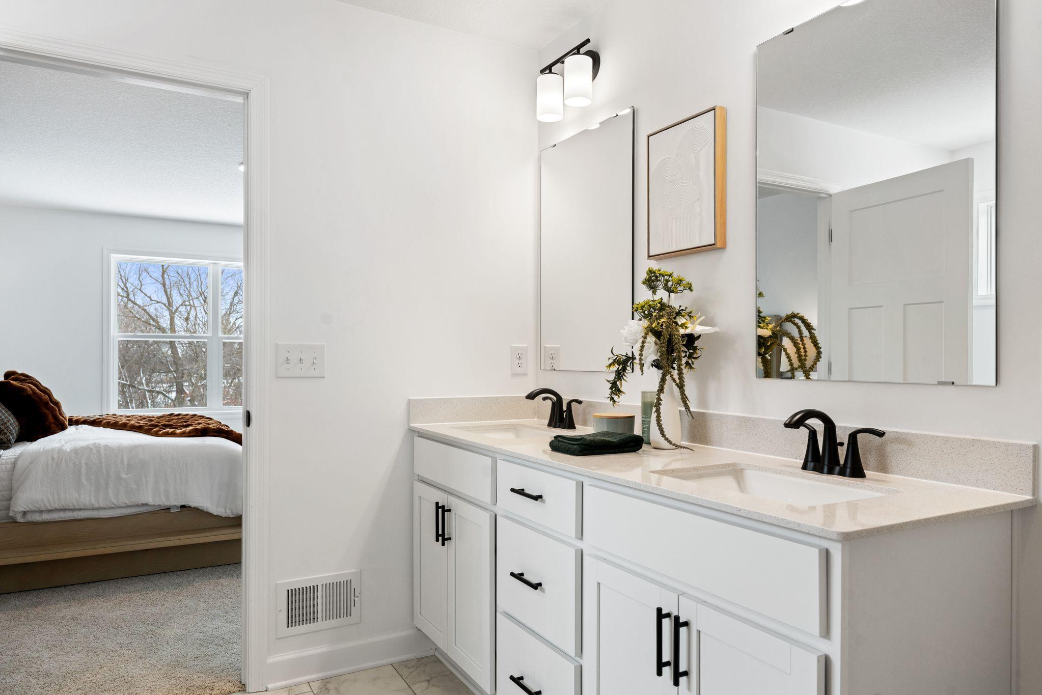 The en-suite bathroom has dual sinks to simplify any morning routine