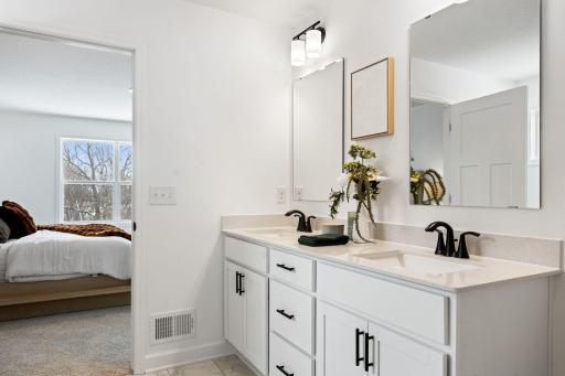 The en-suite bathroom has dual sinks to simplify any morning routine