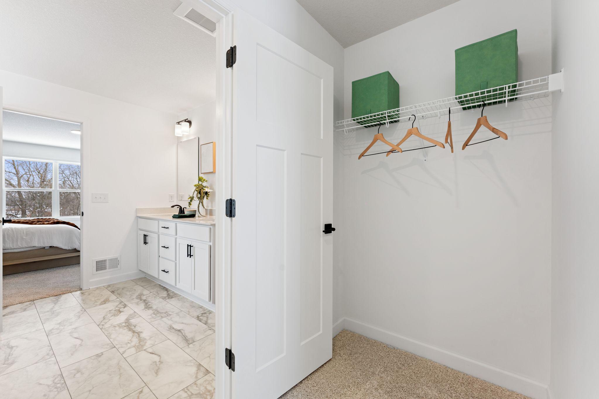 The walk-in closet offers ample space and storage