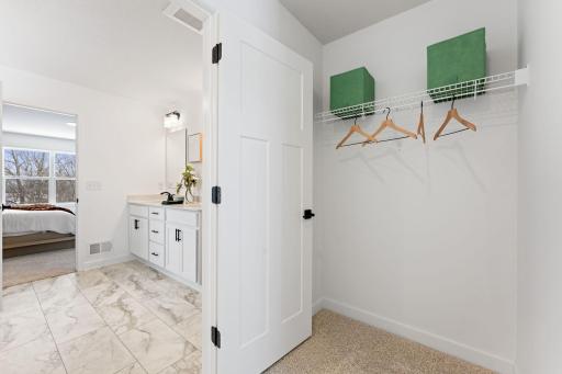 The walk-in closet offers ample space and storage
