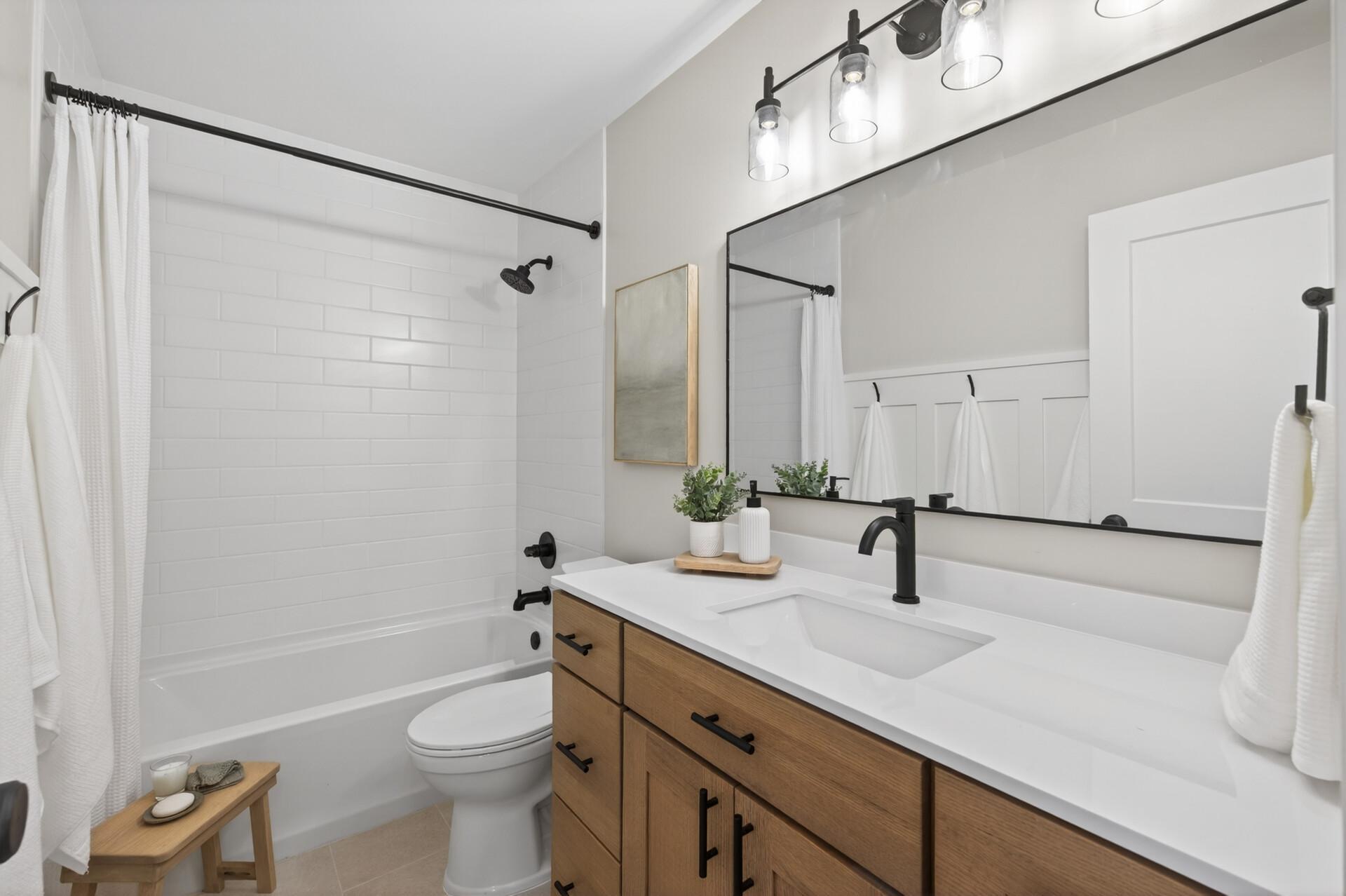 The full upper level bath with clean timeless finishes reflects the consistent quality found throughout the home.