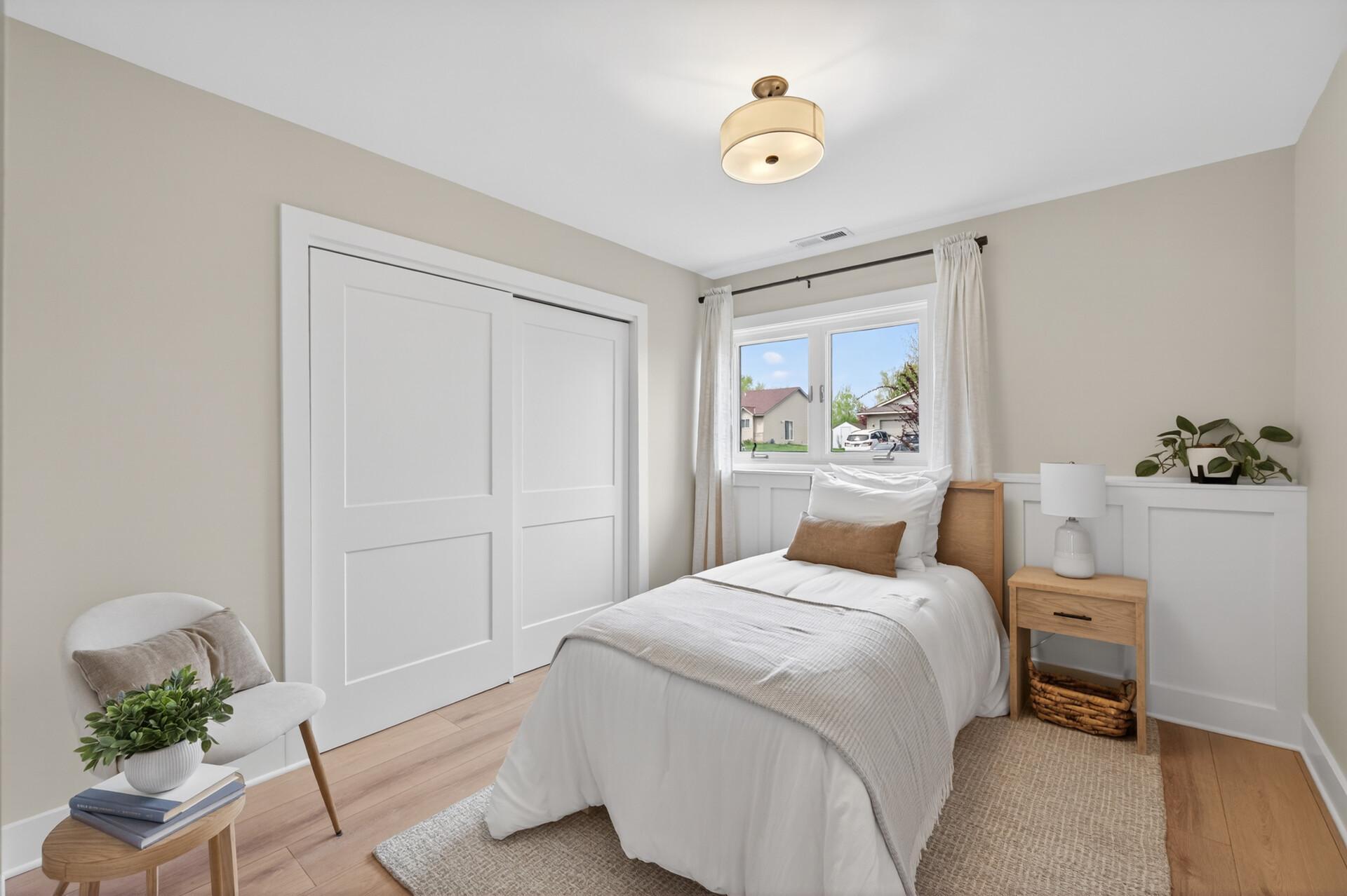 Lower level Bedroom with beautiful wall accents and wide plank flooring.