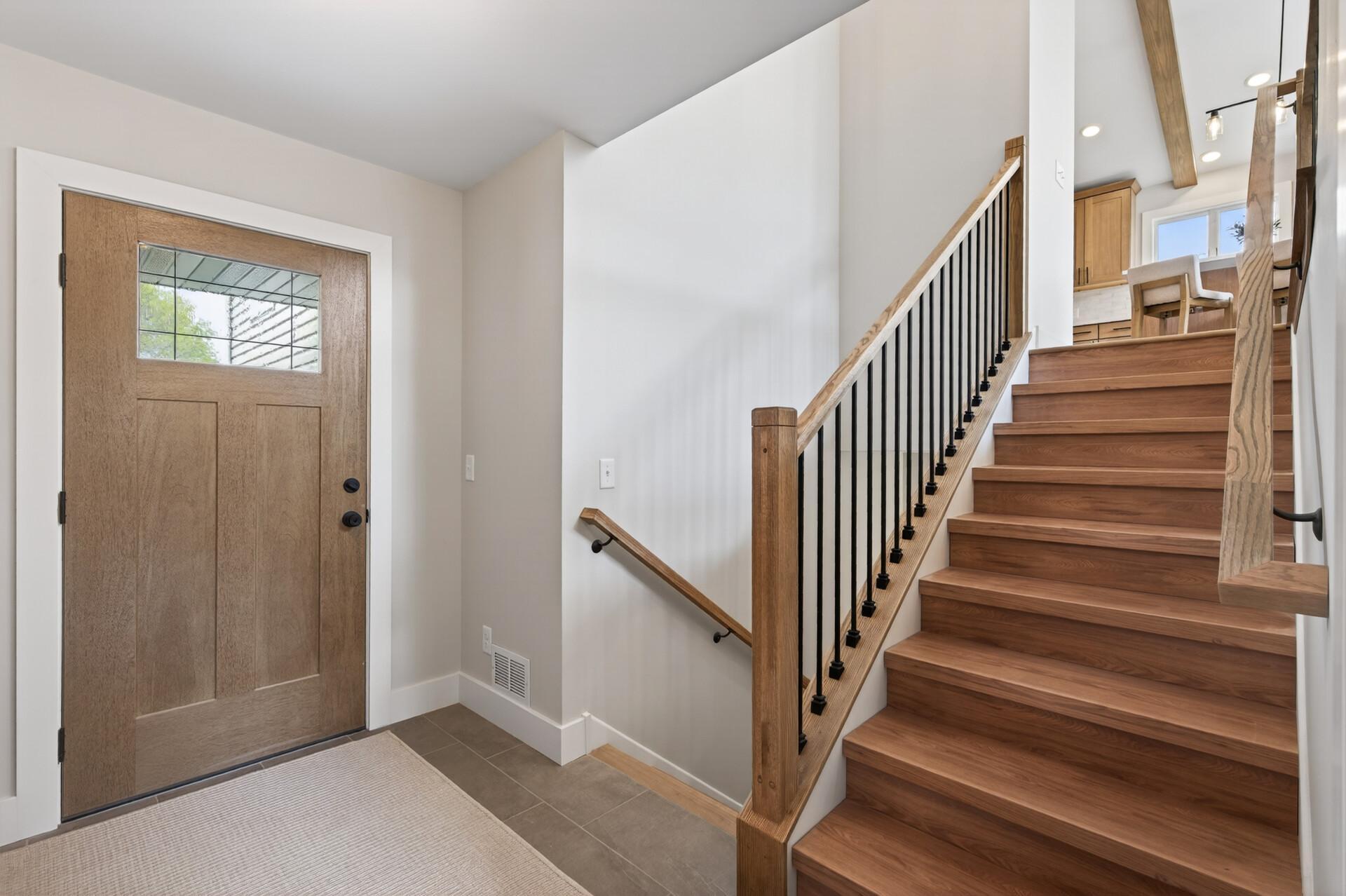 “The thoughtfully designed entry level serves as a highly functional transition space featuring laundry, a stylish half bath, and direct access to both the front entrance and backyard.