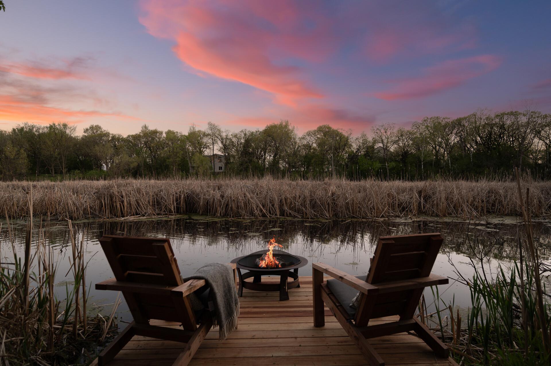 Enjoy quiet evenings by the fire right at the water's edge,, where scenic pond views and colorful sunsets create a setting that feels like a private getaway.