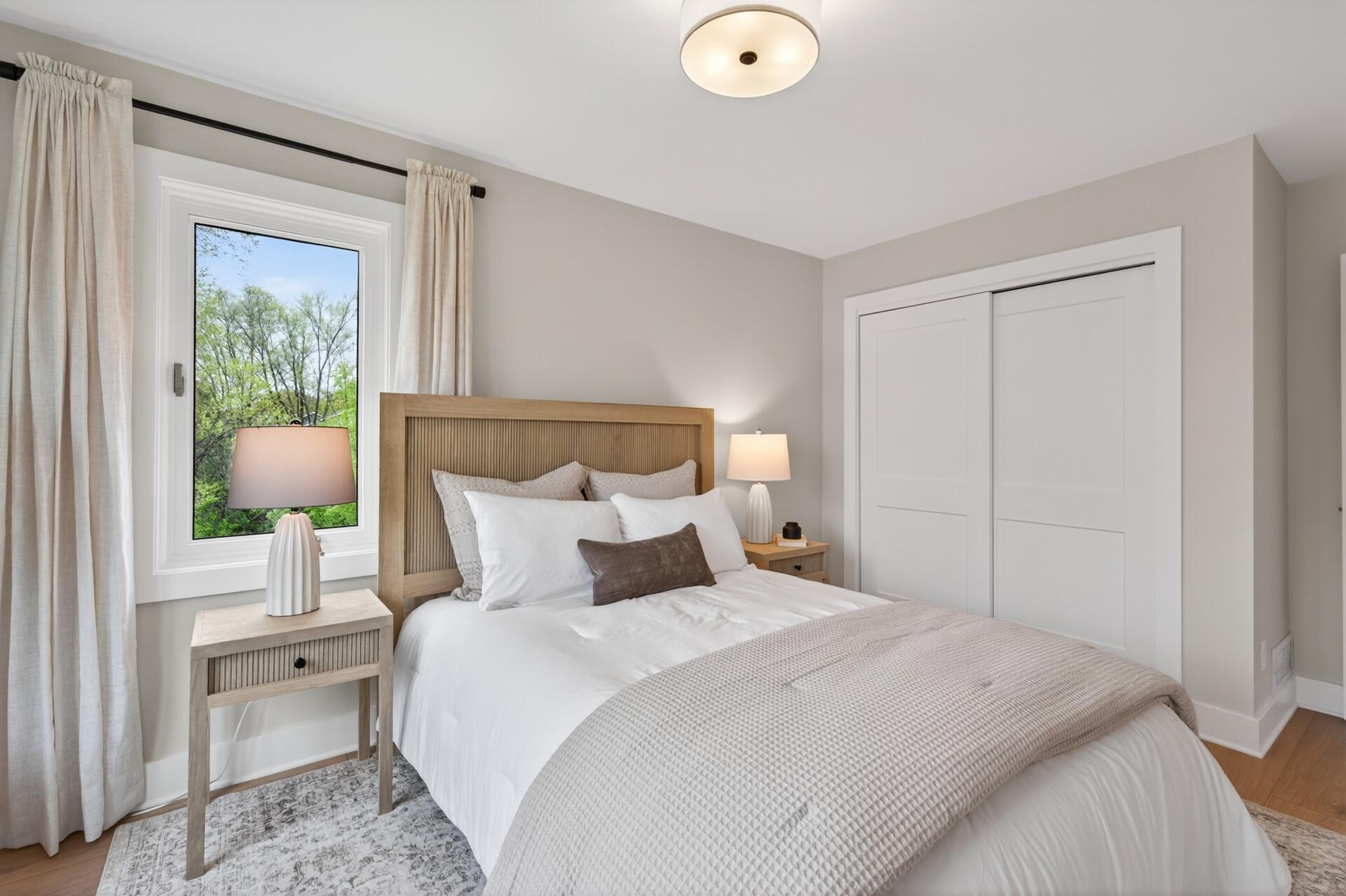 This inviting bedroom offers generous natural light, upgraded finishes and a versatile closet organizer.