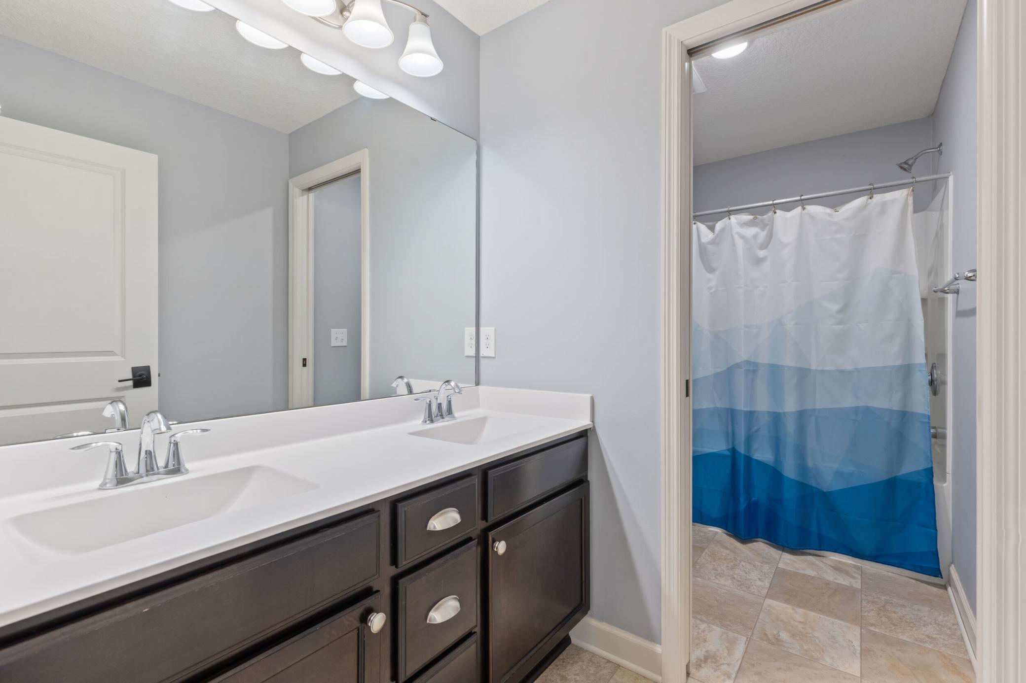 Upper level Full bathroom with dual sinks. Separate bath and shower