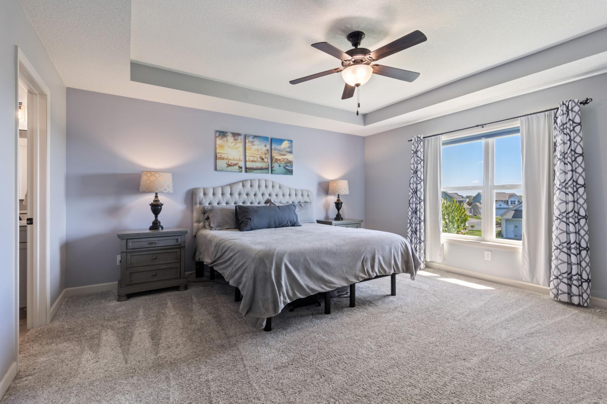 This primary bedroom is so bright and lovely.