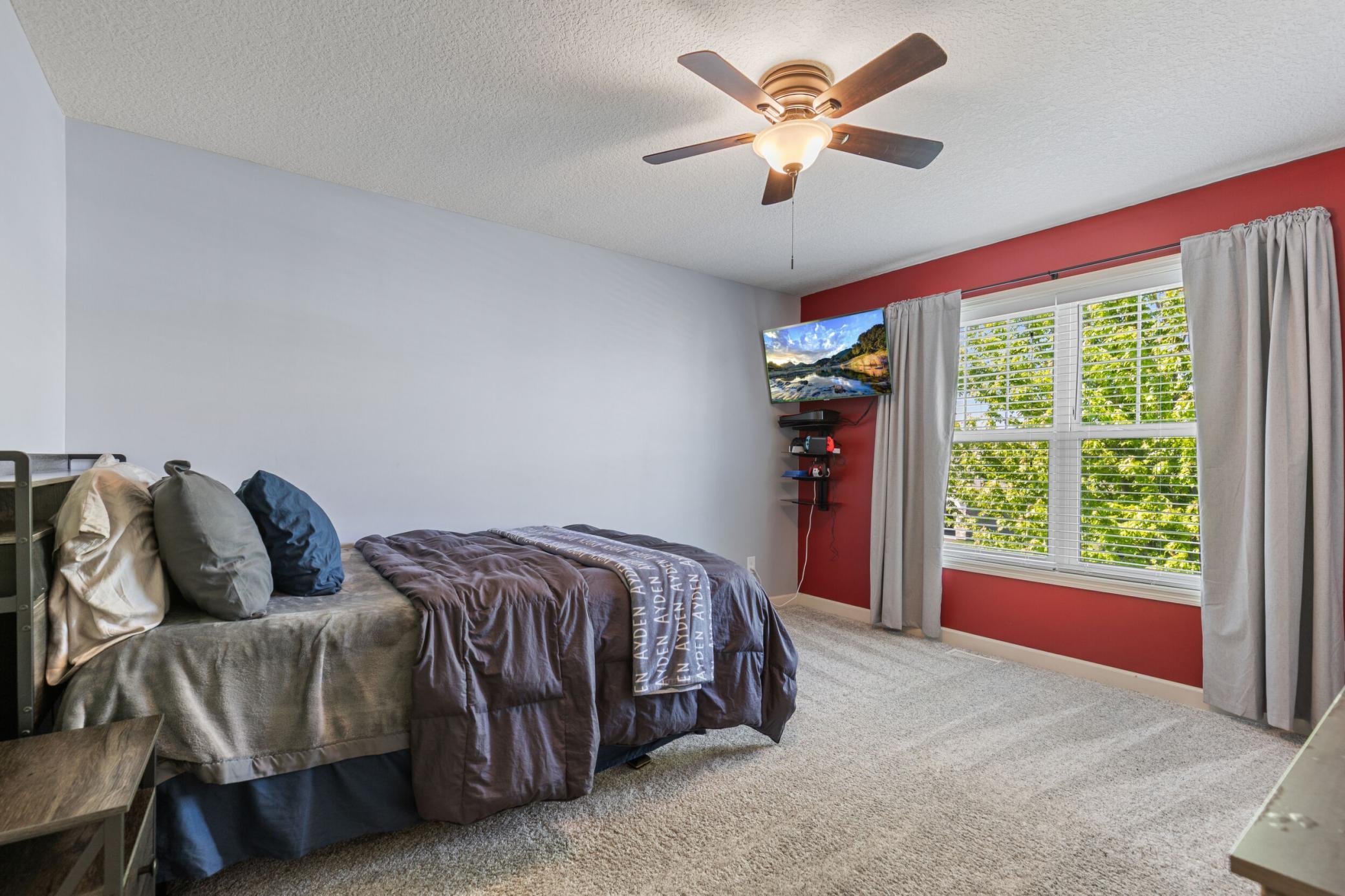 One of the upper level bedrooms with walk in closet, great window and fan.