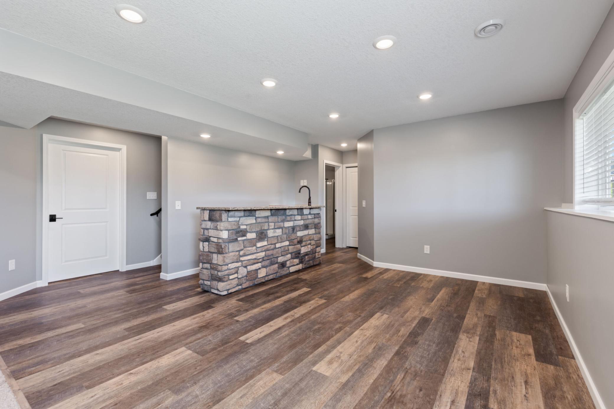 Another photo of the flooring and the bar area. Door at the left leads to the huge storage space and mechanicals.