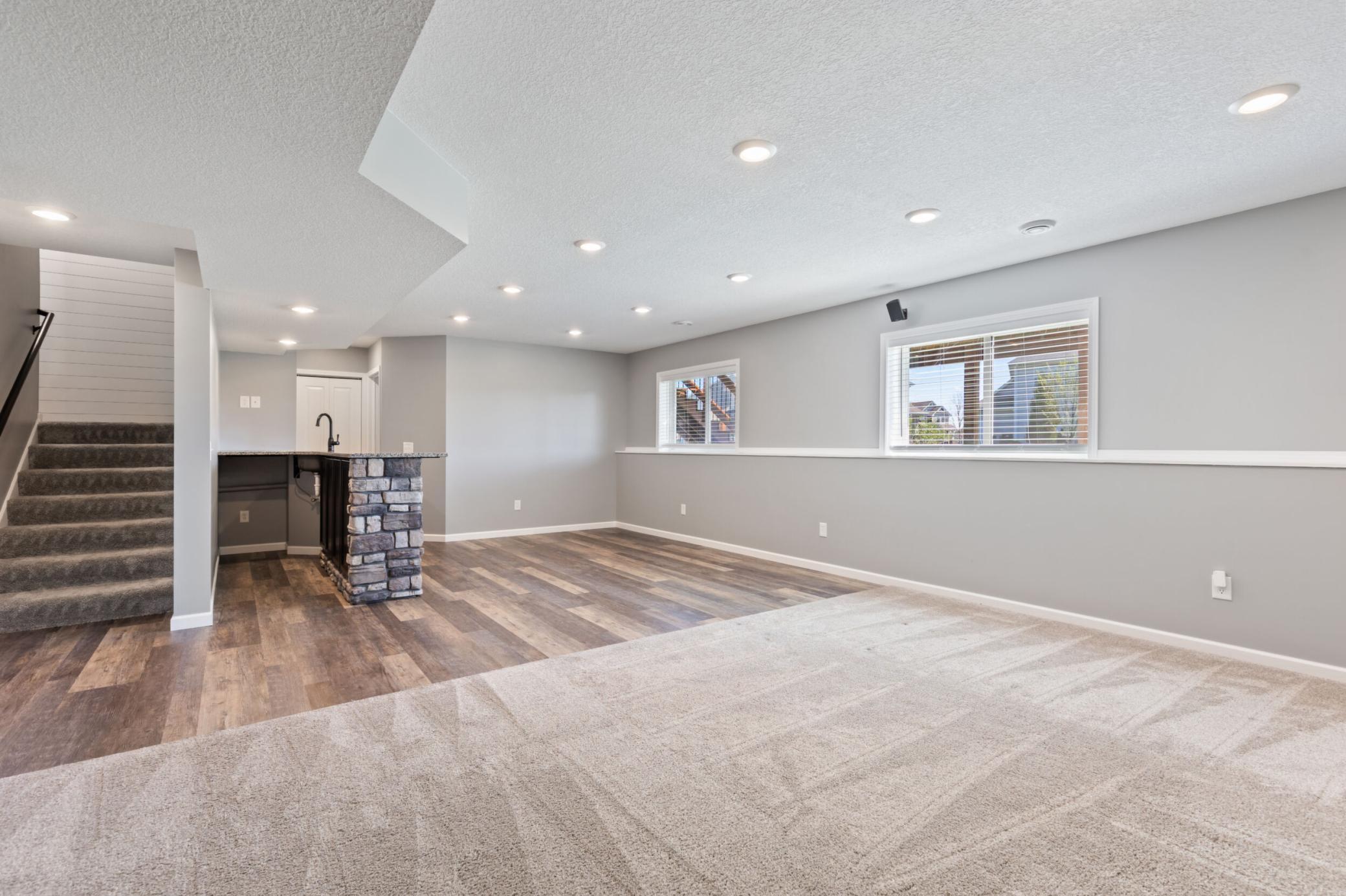 Lower level with so much open space for relaxing, add your game table or pub table by the custom stone surround wet bar.