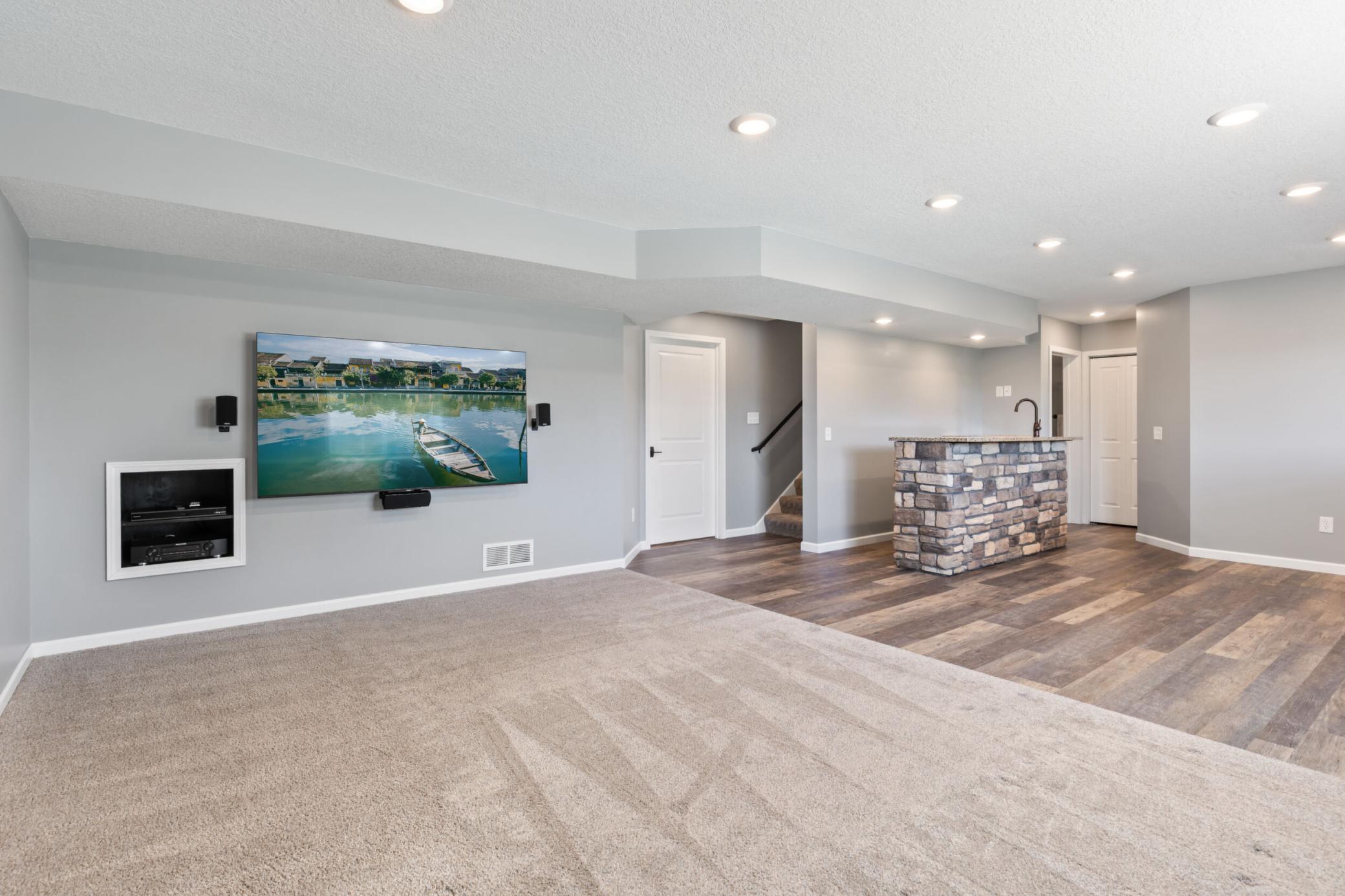Lower level family room provides lots of natural light with look out windows and built in surround sound.