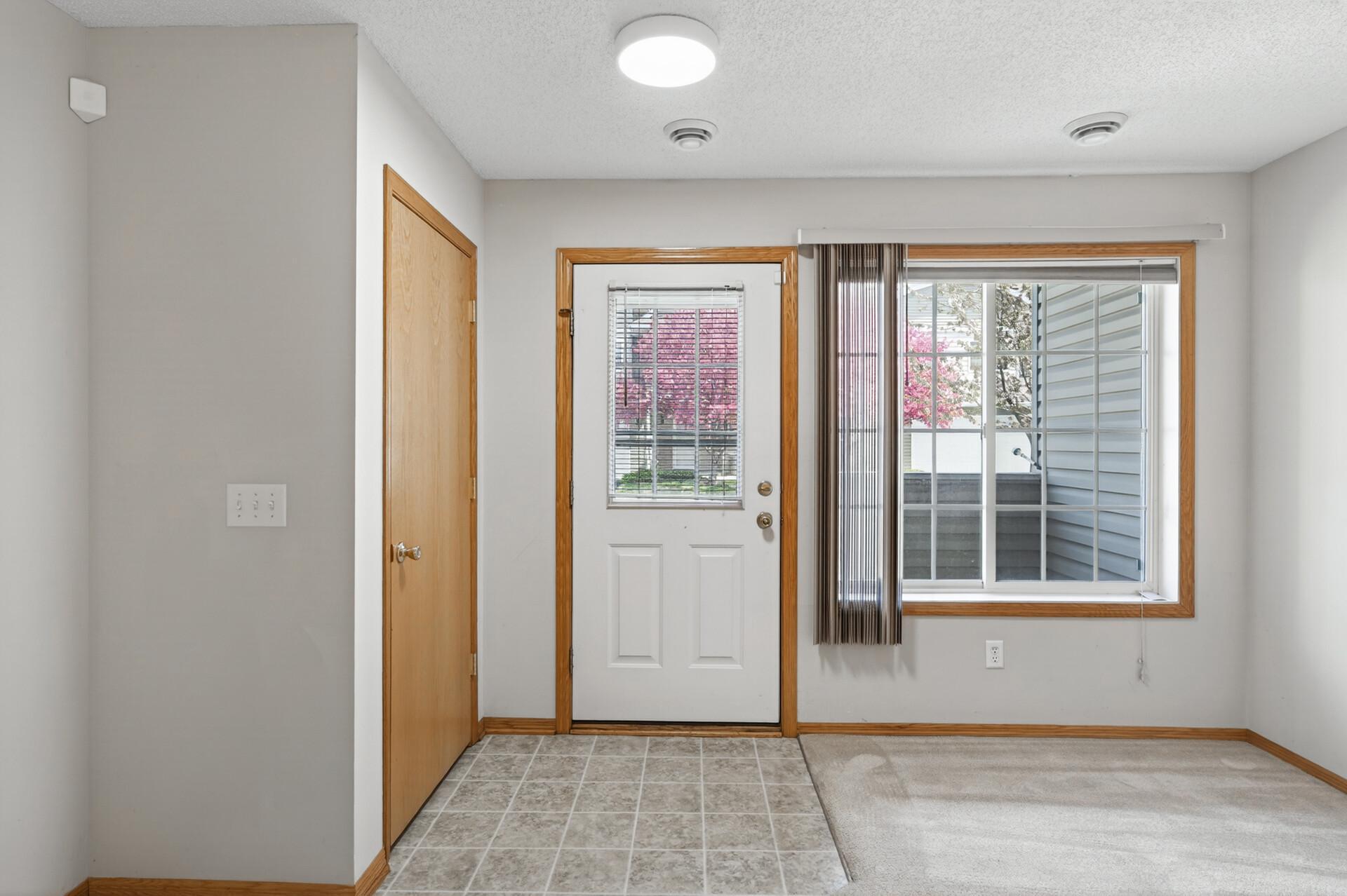 Foyer with coat closet next to it.
