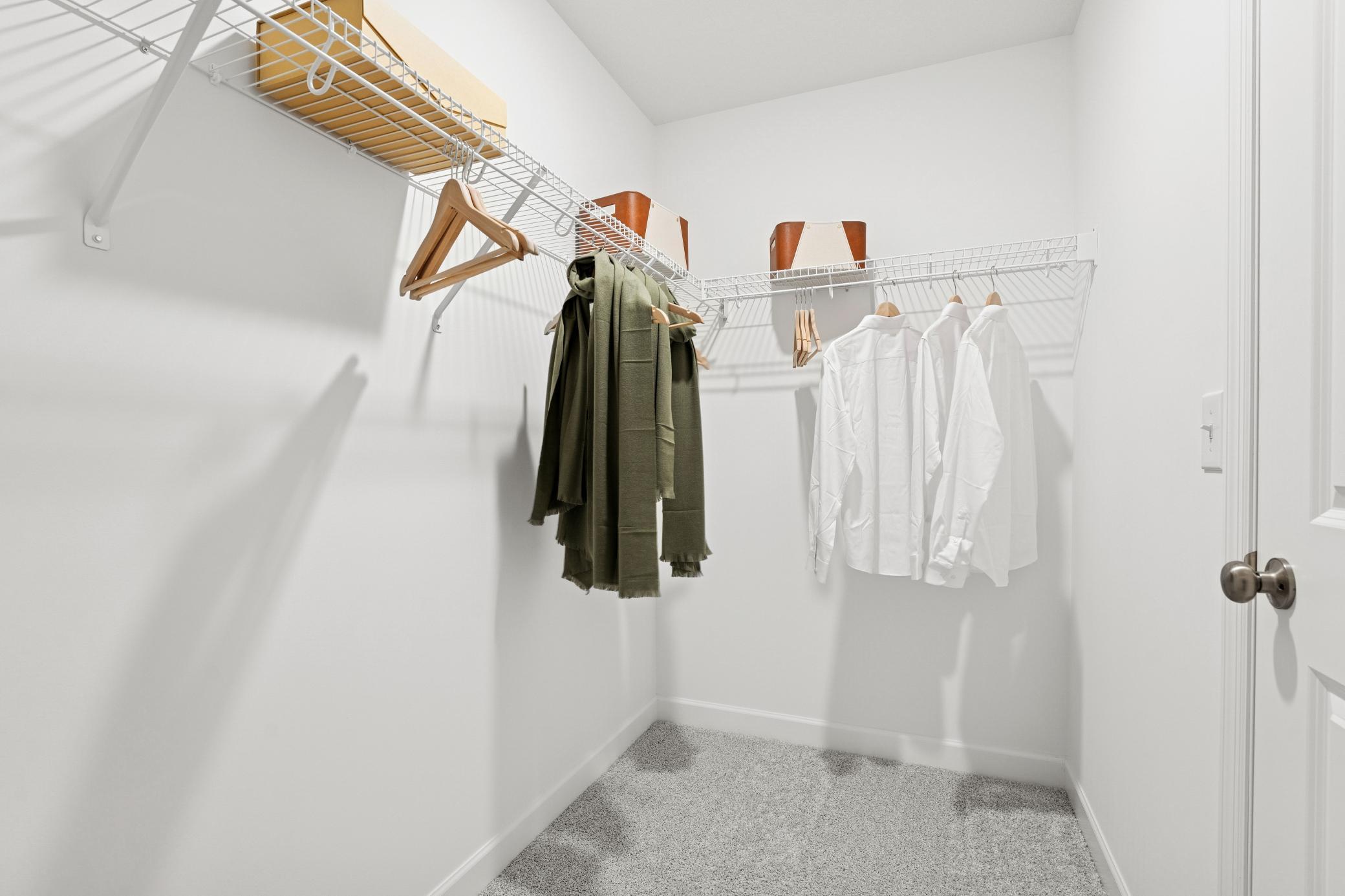 The walk-in closet offers ample space for clothing and accessories with ventilated shelving