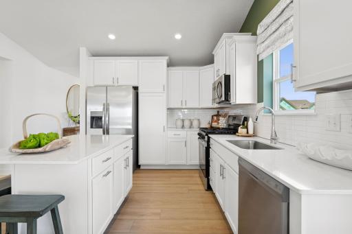 The center island adds additional meal preparation space, and the pull-up seating makes it easy to entertain while cooking
