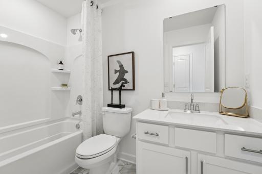 This full-sized bathroom is near the secondary bedrooms and features a single vanity and shower-tub combination.