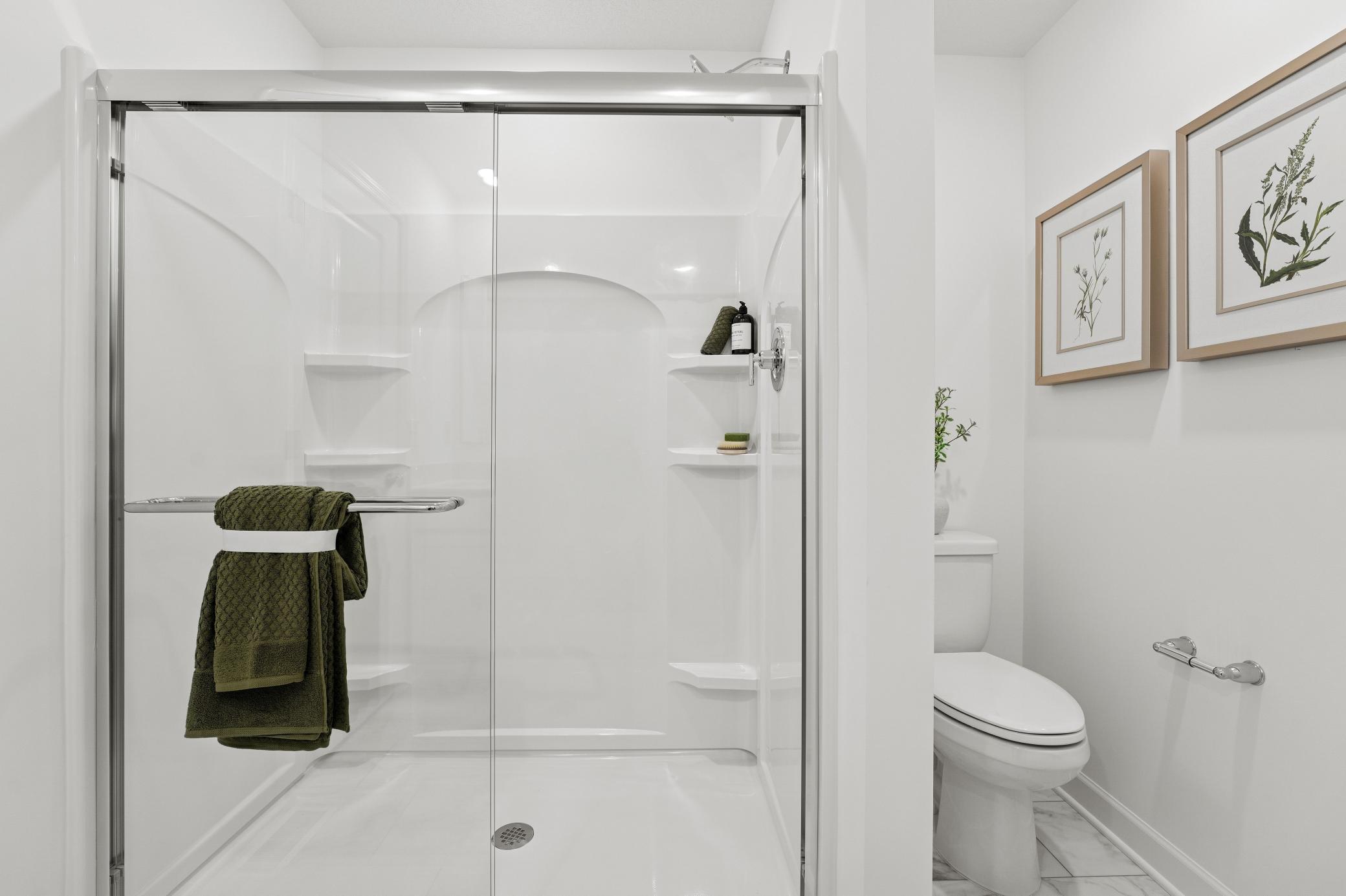 A glass-enclosed shower creates a luxurious atmosphere