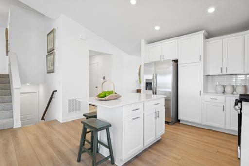 Designer-selected cabinetry throughout the kitchen offers ample storage room for dishware and daily culinary essentials