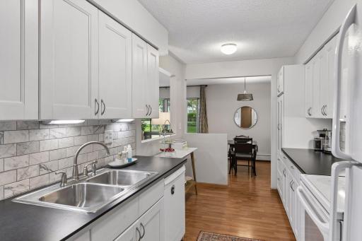Tile back splash, new faucet, dishwasher, under cabinet lighting. Lots of cabinet and counter space.