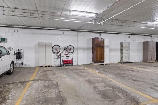 Heated garage stall #18 across from the elevator. Owners provide their own storage cabinets.