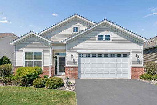Inviting front exterior with charming curb appeal, attached garage, and welcoming covered entry.