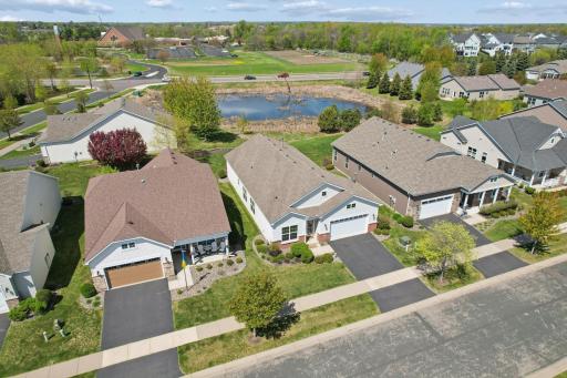 Aerial view of home showcasing prime lot backing to scenic pond with peaceful natural surroundings.
