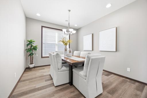 Dedicated dining area with elegant lighting and open archway.