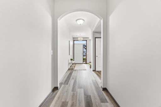 Welcoming entryway with arched architectural detail and durable flooring that flows throughout the main level.