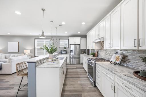 Gourmet kitchen featuring large center island, stainless steel appliances, and open-concept design.