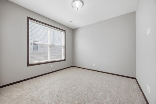 Bright 2nd bedroom featuring neutral finishes and ample natural light.