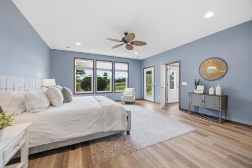 Another view of the giant primary bedroom with large windows, great natural light and scenic backyard views.