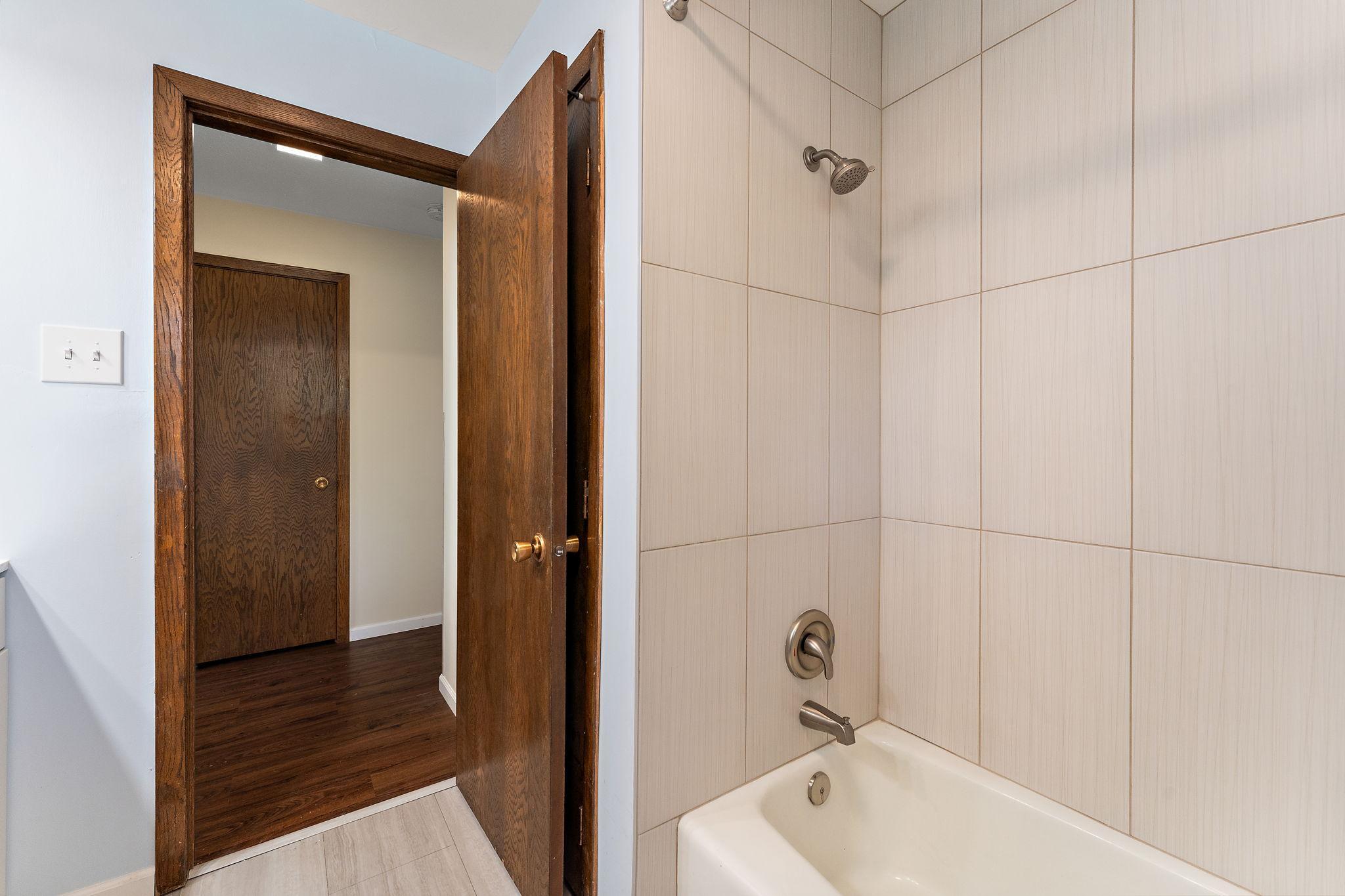 ...Tile shower walls, faucet & shower head.