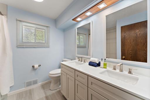 The BRAND NEW (completed last week!) main floor bath. It's all new- vanity, siks, faucets, paint, flooring, mirrors, lighting....