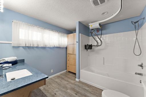 The primary bath has an over sized jetted tub & roll under sink. Pictured is the lift, which can be removed.
