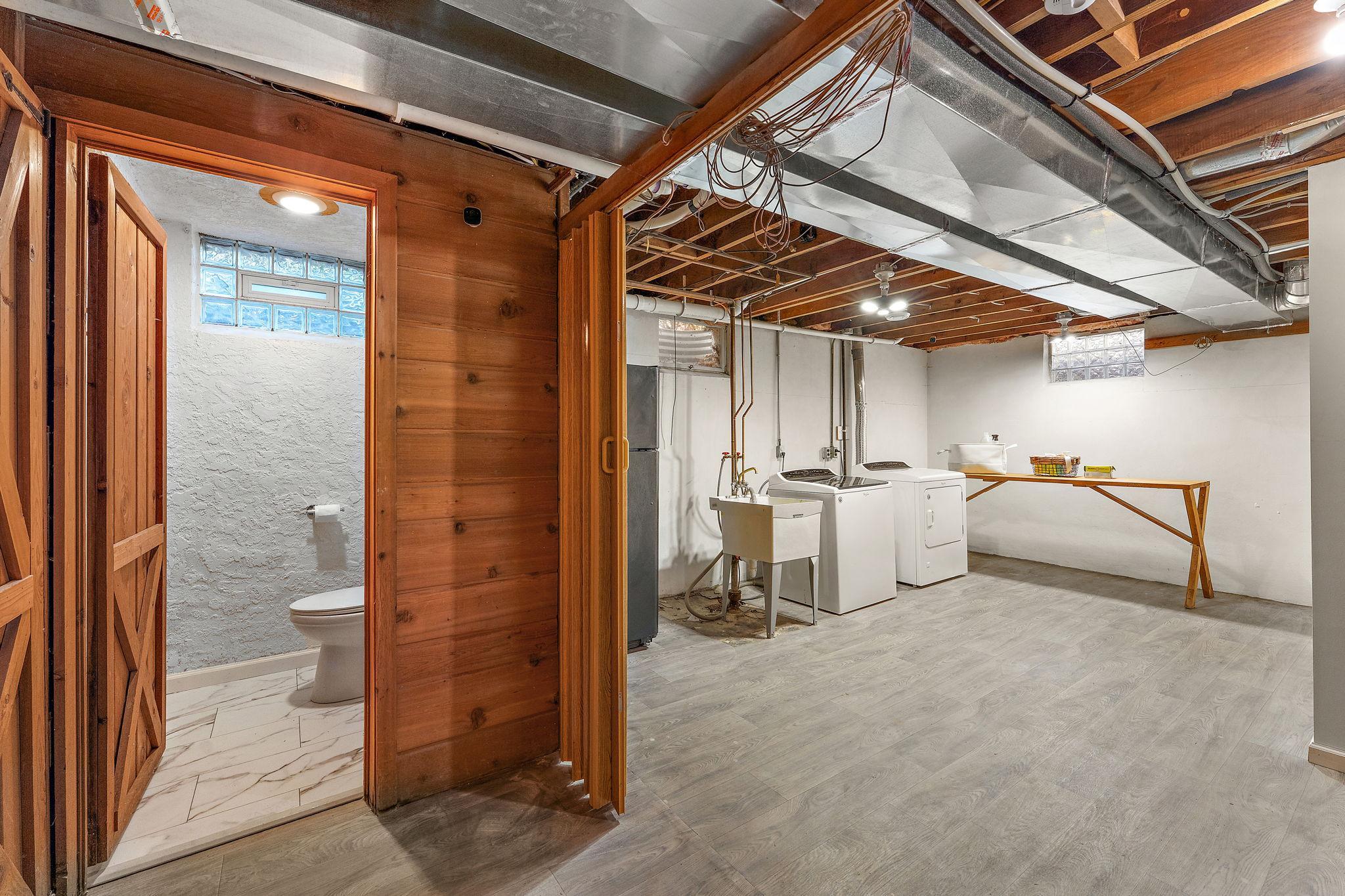 The expansive laundry room can be closed off with acoridian doors (big in the 50's/60's). Yo will find all new flooring in the laundry room & 3/4 bath.