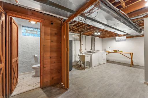 The expansive laundry room can be closed off with acoridian doors (big in the 50's/60's). Yo will find all new flooring in the laundry room & 3/4 bath.