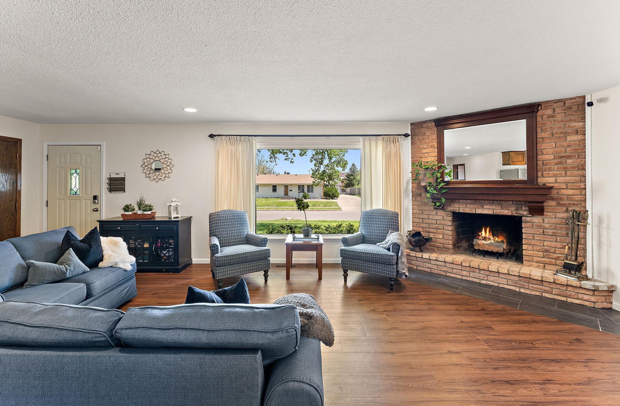 The Living Room has a wood burning fireplace with an extended hearth to be code compliant.