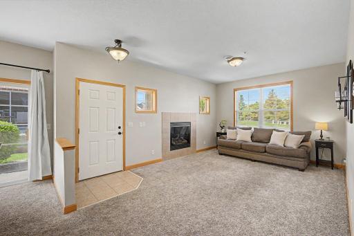 View from the kitchen into the living room. Lots of windows streaming in natural light and a cozy gas fireplace for those cool evenings.