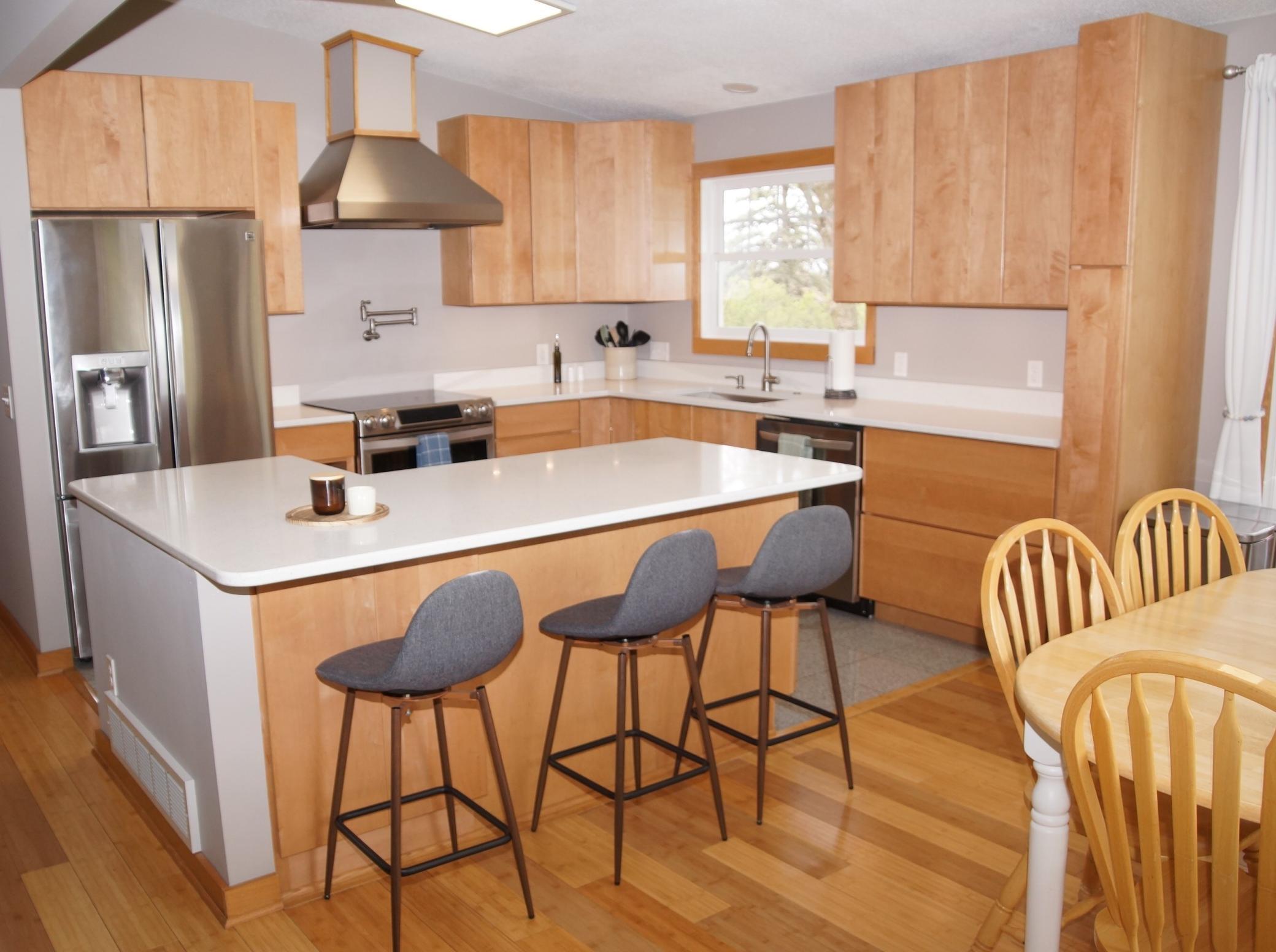 Recently updated Kitchen features Built-in Center Island with Storage and Microwave shelf! High End Maple Cabinetry, Quartz Counter Tops, Stainless Steel Appliances!
Bamboo Flooring runs through the dining area with Tile flooring in Kitchen Area!