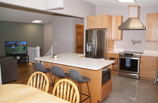 Recently updated Kitchen features Built-in Center Island with Storage and Microwave shelf! High End Maple Cabinetry, Quartz Counter Tops, Stainless Steel Appliances!
Bamboo Flooring runs through the dining area with Tile flooring in Kitchen Area!