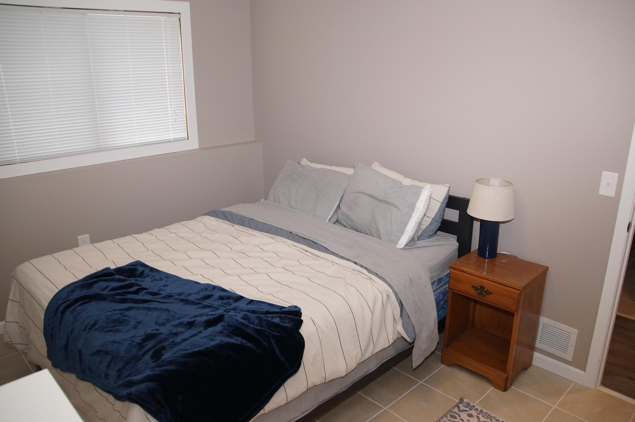 3rd Bedroom is in the Lower Level, sports Newer window, Tile floors. There is a Similar Fourth Bedroom across the hall currently being used for storage for the move. (no picture)