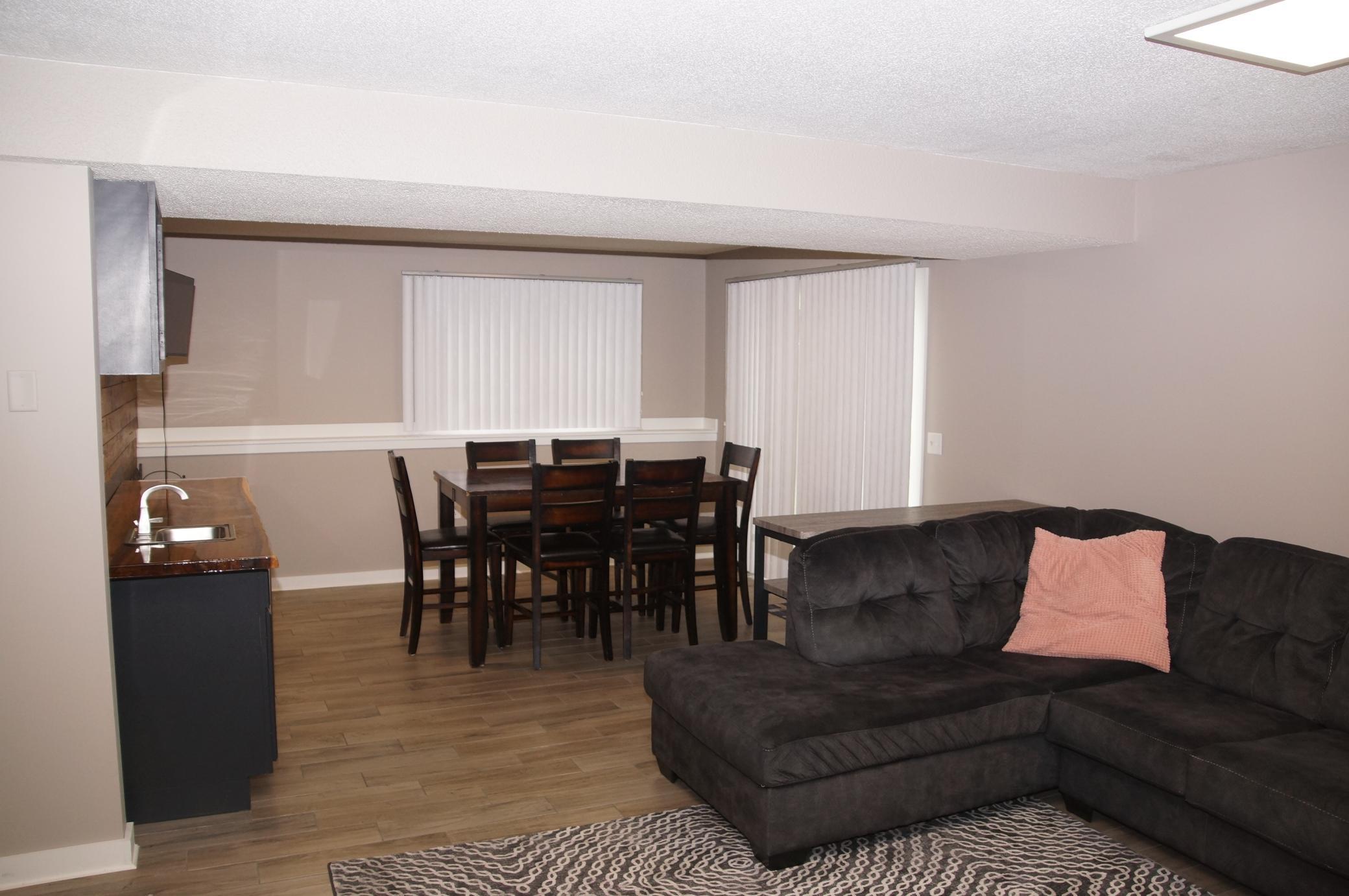 Wet Bar and Game Table Area next to the Walk-Out Siding Door to Patio and Back Yard!