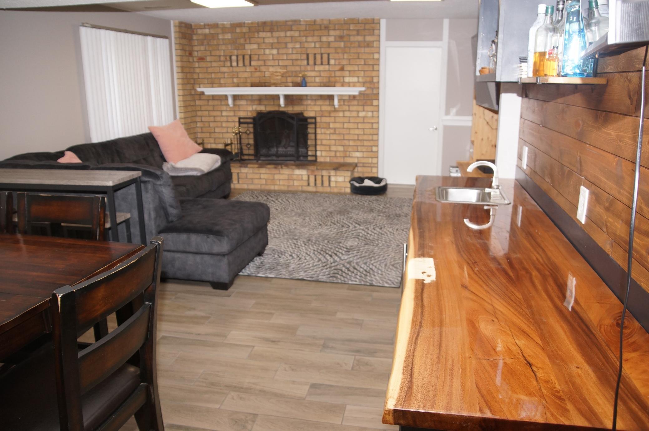 Amusement Room has a Brick Fireplace with built-in Heatolater! Sit around and enjoy the warmth of the fire!
Plus there is a 2nd access door to garage!