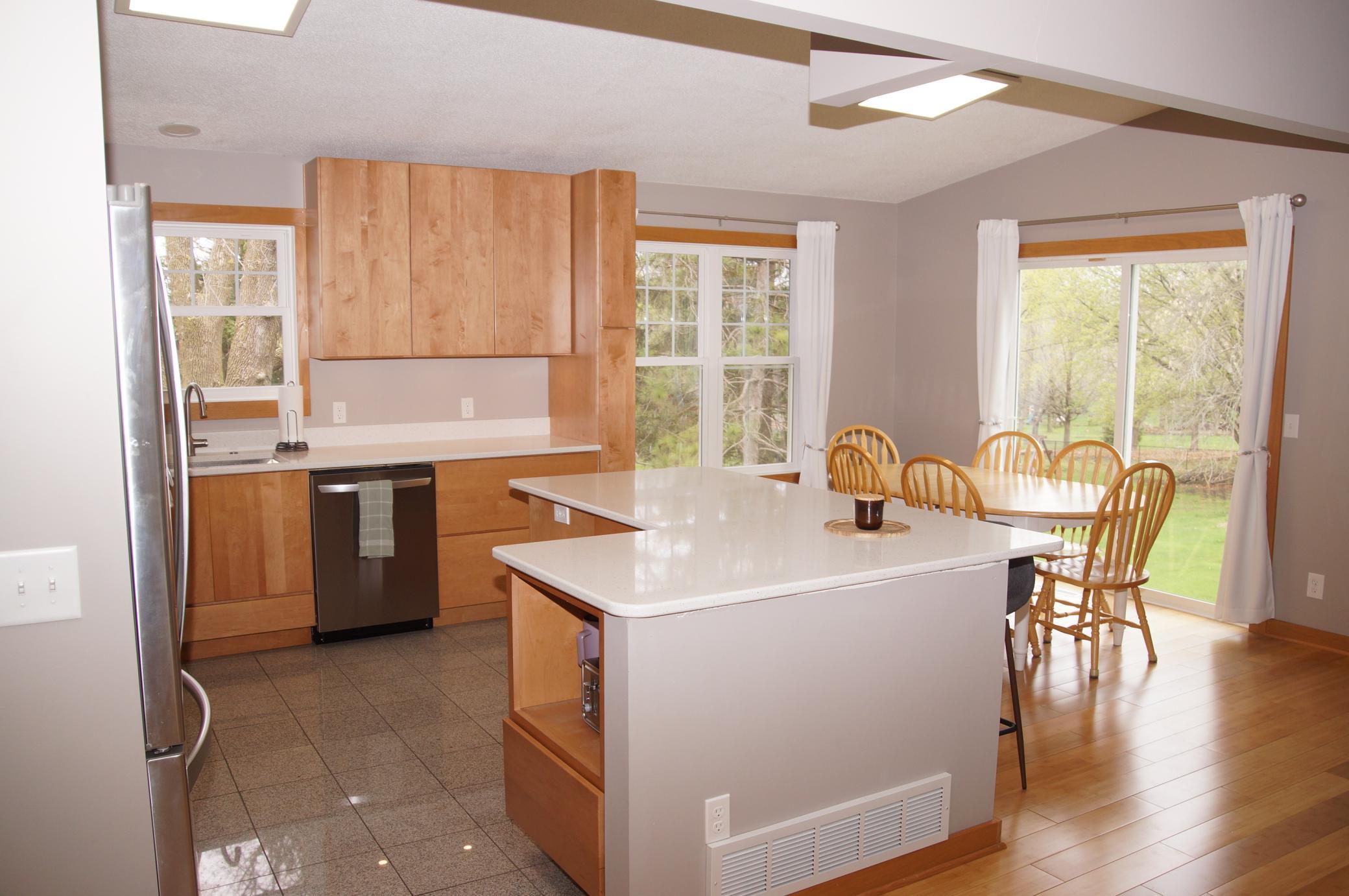 Recently updated Kitchen features Built-in Center Island with Storage and Microwave shelf! High End Maple Cabinetry, Quartz Counter Tops, Stainless Steel Appliances!
Bamboo Flooring runs through the dining area with Tile flooring in Kitchen Area!