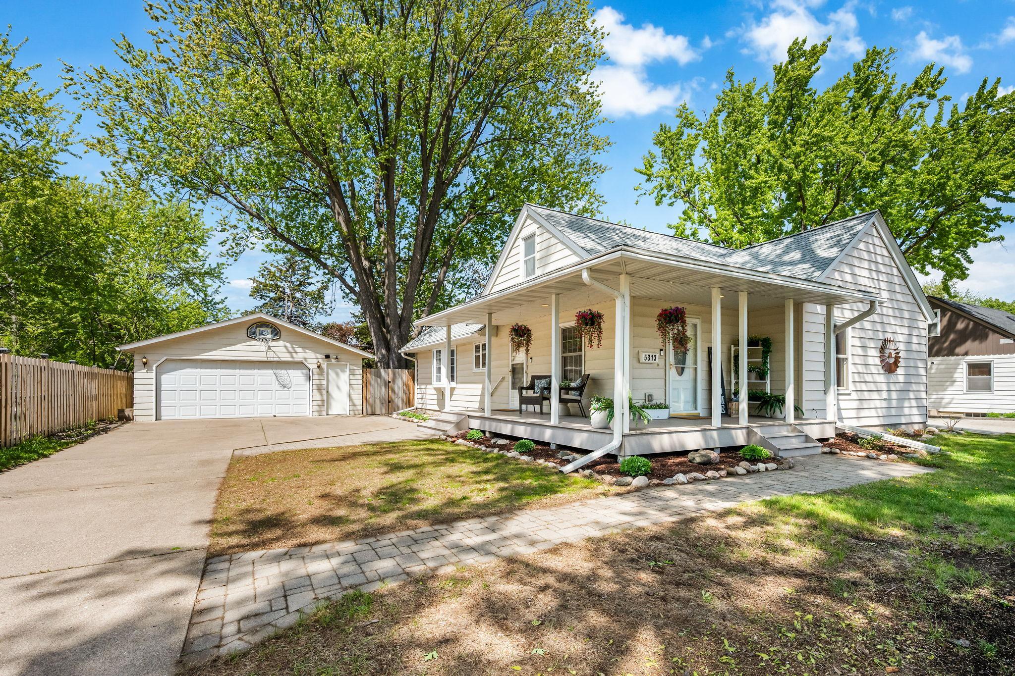Adorable front wrap around porch that is so inviting!