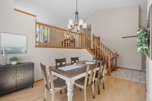 The dining room is filled with natural light and has vaulted ceilings.