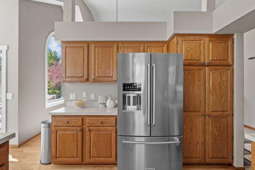 View of the fridge and ample pantry storage in the kitchen.