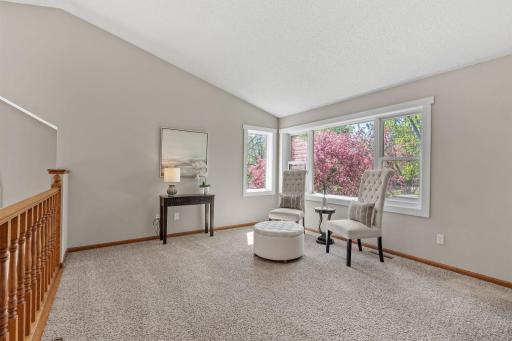 The upper level living room provides a connected flow to the dining and kitchen.